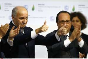 French President Francois Hollande, right, and French Foreign Minister and president of the COP21 Laurent Fabius react after the final conference at the COP21, the United Nations conference on climate change, in Le Bourget, north of Paris, Saturday, Dec.12, 2015. Governments have adopted a global agreement that for the first time asks all countries to reduce or rein in their greenhouse gas emissions. (AP Photo/Francois Mori)/PAR173/608372693275/1512122025